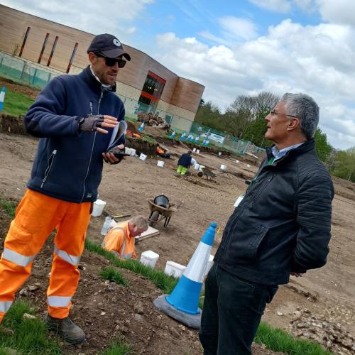 Eric Buckmaster (on right) pictured on a site visit to the archaeological excavations at Grange Paddocks.  Talking to one of the archaeologists.